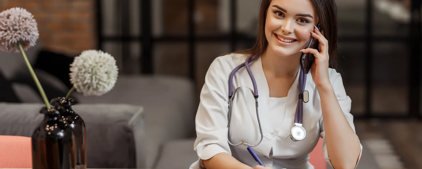 beautiful young female medical private doctor is looking camera smiling while give recipe call